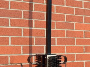 A Baughurst Bootwiper, consisting of a black pole with a brush attached