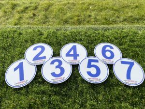 Set of numbered sports markers on grass for outdoor activities