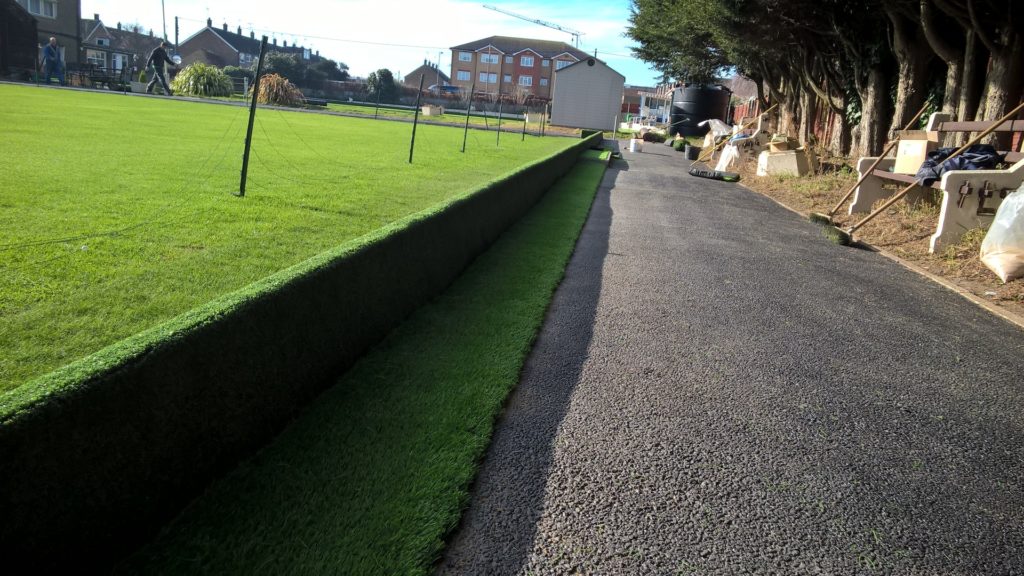 WP_20160211_11_05_56_Pro A road running through artificial grassy area