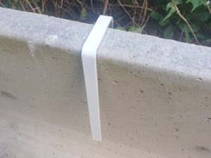 Club rink dividers mounted on a stone wall